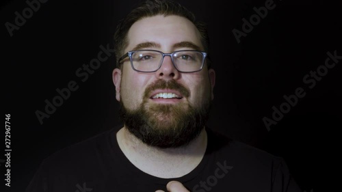 Motion studio portrait of a bearded man expressing interest and wonder photo