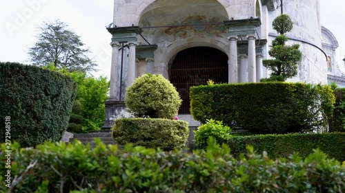 A mother and her little daughter carrying a teddy bear visiting the sacred mountain of Varallo christian devotional complex, a unesco world heritage site near the town of Varallo Sesia in Italy