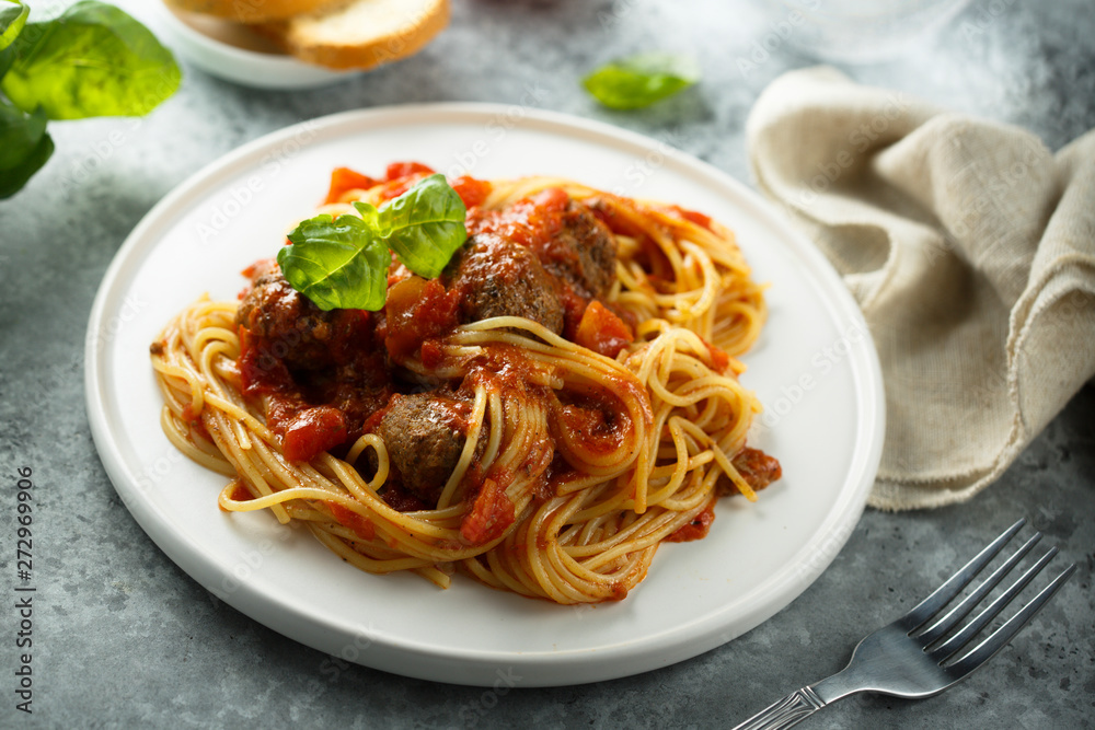 Pasta with meatballs, tomato sauce and basil