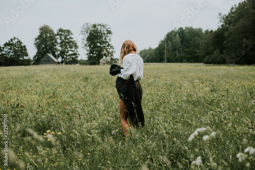 Folk girl in the midsummer making flower