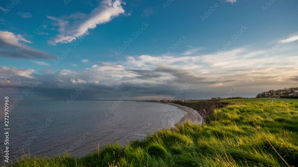 Timelapse of approaching storm over coastal bay and cliffs. Timelapse of approaching storm over coastal bay and cliffs.