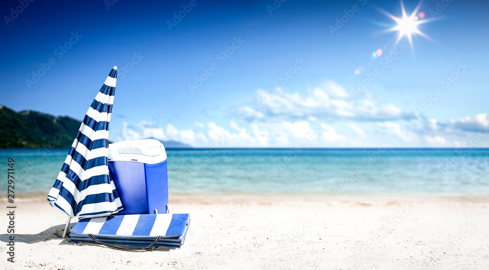 Summer background of beach with umbrella and ocean landscape. Sunny day and blue sky. 