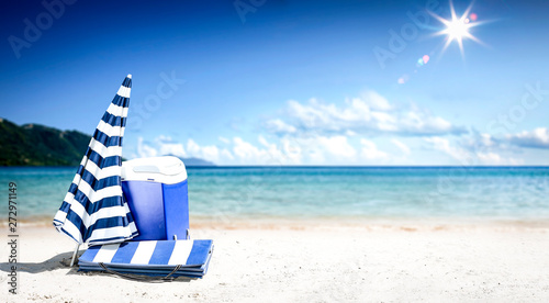 Summer background of beach with umbrella and ocean landscape. Sunny day and blue sky. 