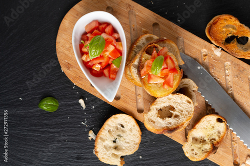 Healthy food concept homemade organic vegan Tomatoes Bruschetta with roasted baguette with copy space