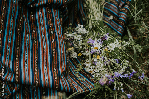 Folk girl in the midsummer making flower