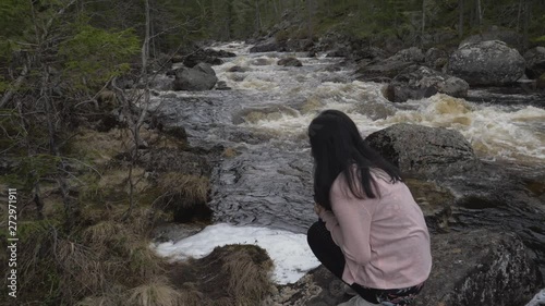 Girl finds something in the river. photo