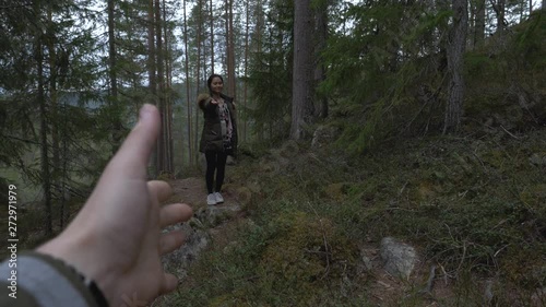 Girl invites cameraman to come along in the forest. Slowmotion photo