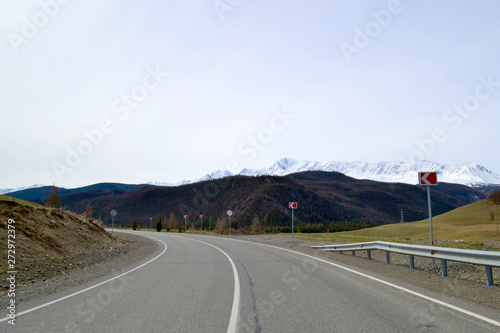 Empty road with signs to the mountains.