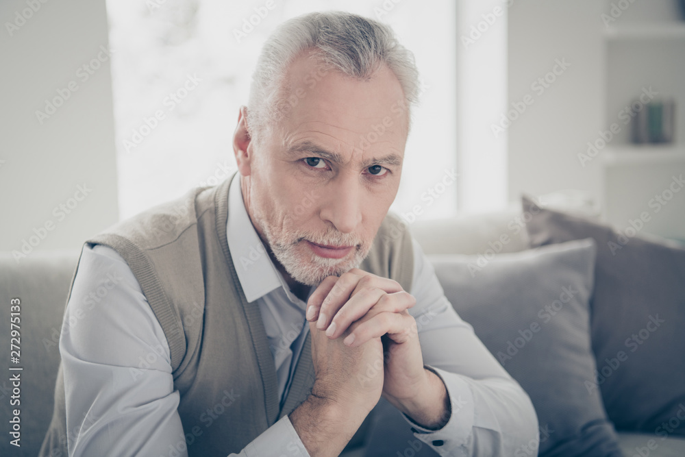 Close up photo amazing he him his aged man silent hands arms together calm peaceful bossy chief look wear white shirt waistcoat pants sit cozy comfort divan bright flat house living room indoors Close up photo amazing he him his aged man silent hands arms together calm peaceful bossy chief look wear white shirt waistcoat pants sit cozy comfort divan bright flat house living room indoors