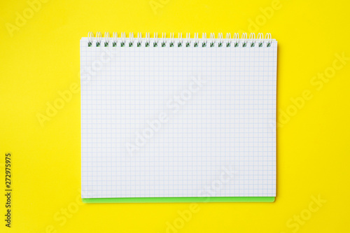 Clean white notebook and pencil with copy space on yellow table background for presentation, writer or school education, blogger, novel and friction or brand story concept.