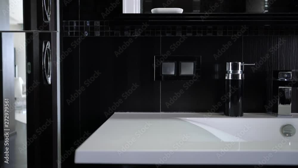 Sink in modern black bathroom interior. Slide close up video. Sink in modern black bathroom interior. Slide close up video.