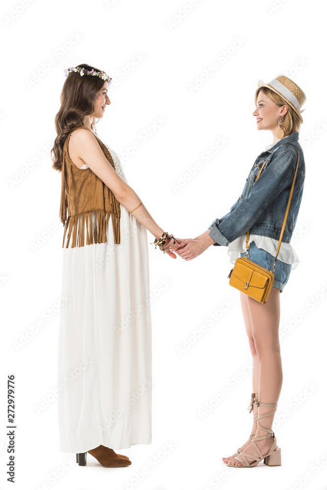 side view of bisexual hippie couple expecting baby and holding hands isolated on white