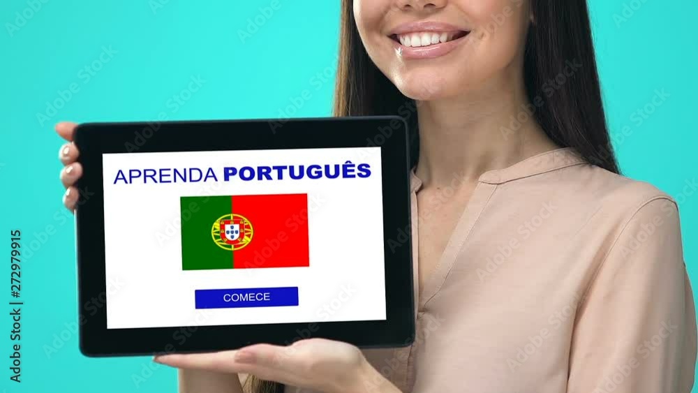 Excited woman holding tablet with learn Portuguese language app, education Excited woman holding tablet with learn Portuguese language app, education