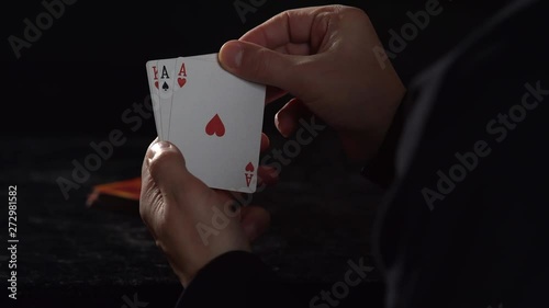 CU SLOW MOTION: Five card draw poker player reveals Ace in hand, slowly uncovers remaining cards to show full house - Kings over Aces photo