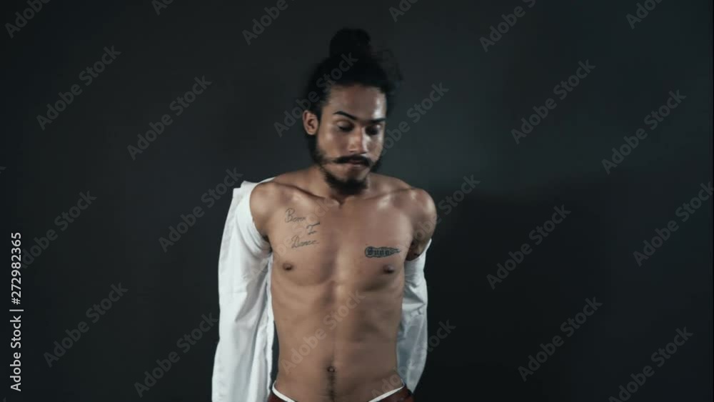 Sexy indian man going topless with extreme confidence, portrait shot