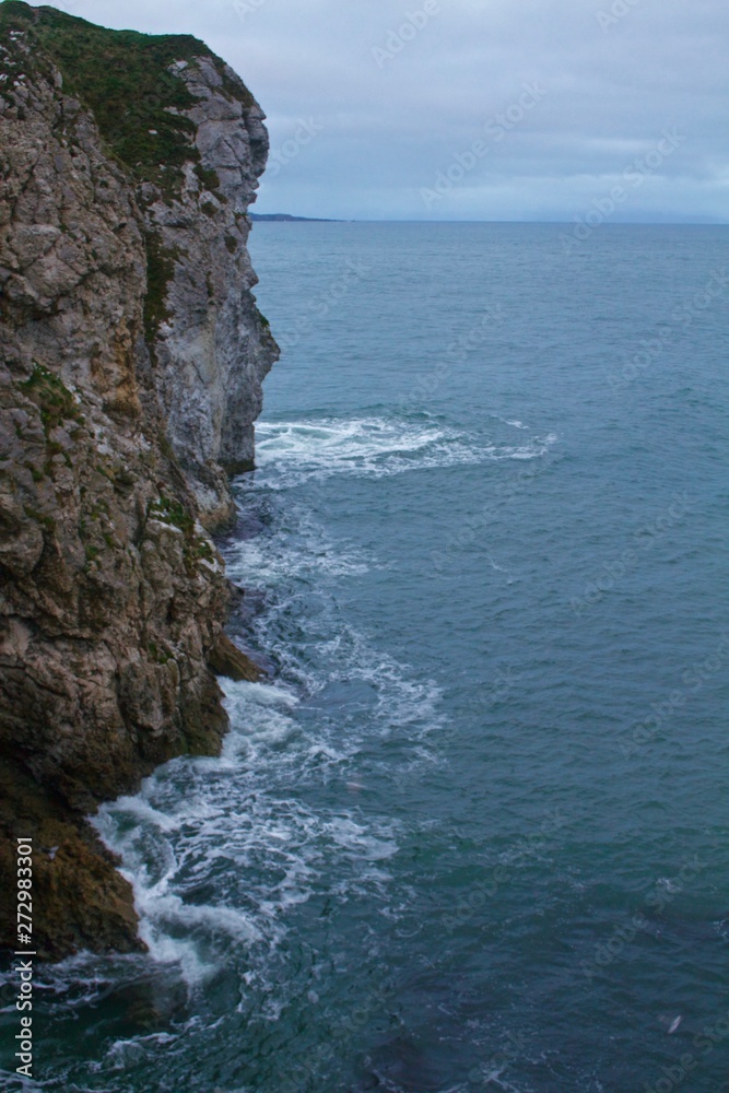 Tall Rocky, Moss, Cliffs Overlooking Blue Atlantic Ocean, Ireland