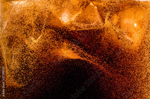 Fotografie Close up view of the ice cubes in dark cola background