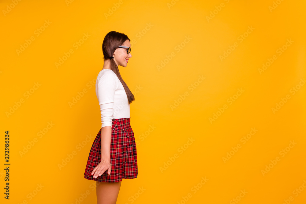 Profile side view portrait of her she nice-looking sweet attractive lovely cheerful cheery girl wearing uniform standing straight isolated over bright vivid shine yellow background Profile side view portrait of her she nice-looking sweet attractive lovely cheerful cheery girl wearing uniform standing straight isolated over bright vivid shine yellow background
