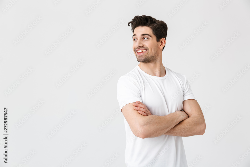Happy young excited emotional man posing isolated over white wall background. - obrazy, fototapety, plakaty 