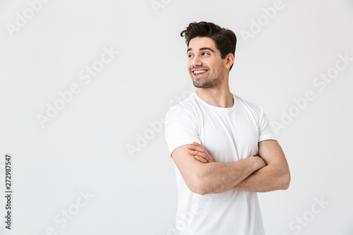 Happy young excited emotional man posing isolated over white wall background. © Drobot Dean