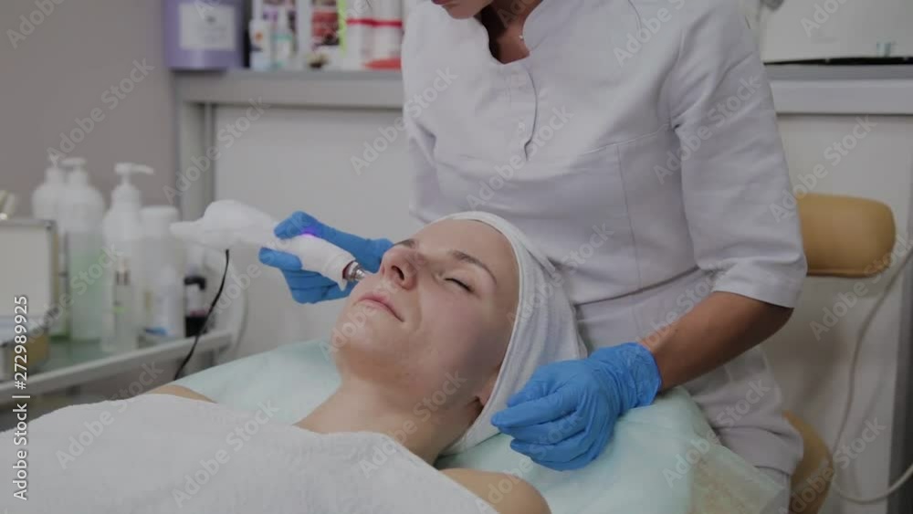 Professional cosmetologist performs DermaPen procedure in a cosmetology clinic. Professional cosmetologist performs DermaPen procedure in a cosmetology clinic.