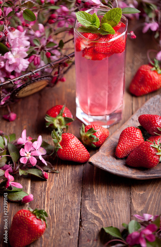 strawberry lemonade with strawberries and flowers food background