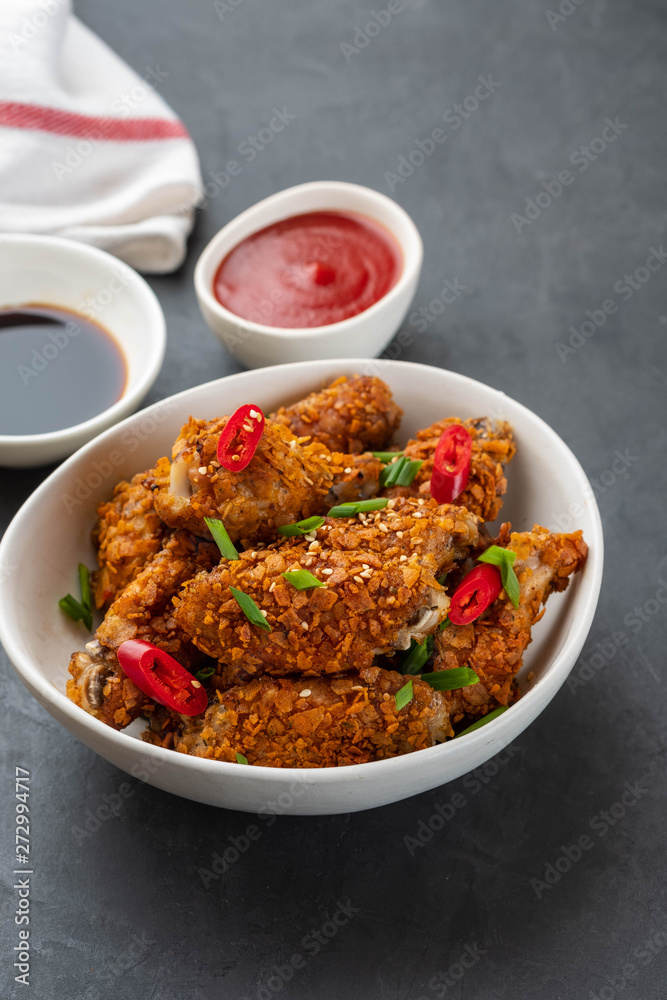 Chicken nuggets with sauce and pepper on a dark background. Copy space. Chicken nuggets with sauce and pepper on a dark background. Copy space.