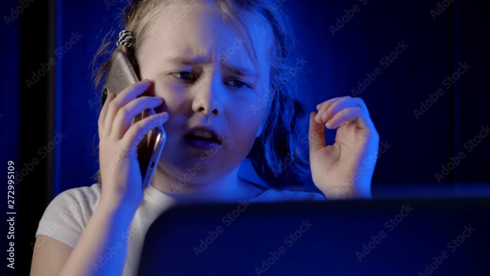 Close-up shot of a young little girl talking on her fance smartphone.
