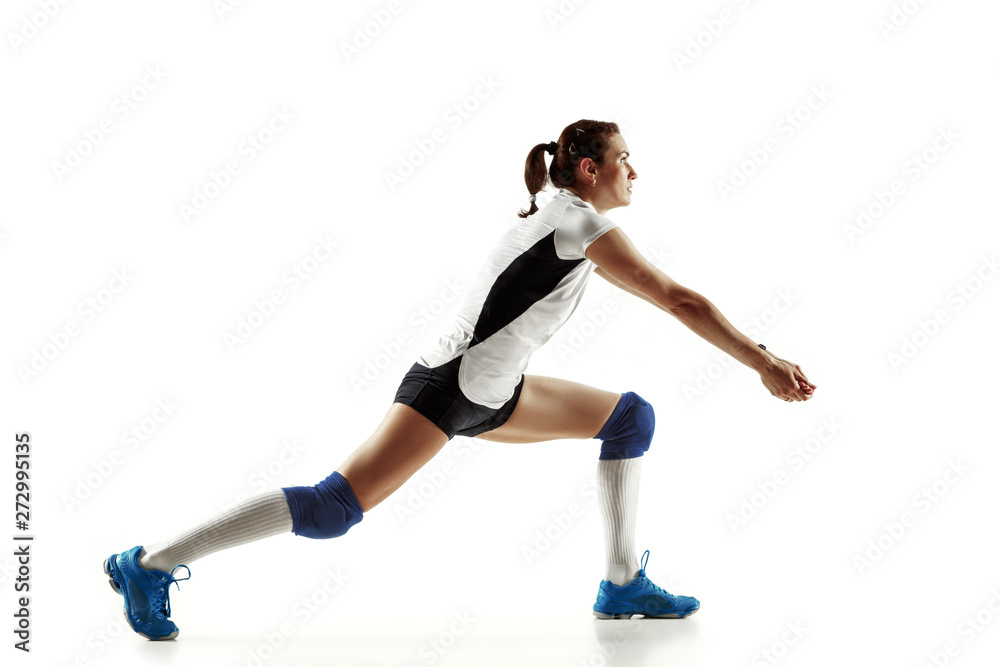Young female volleyball player isolated on white studio background. Woman in sport's equipment and shoes or sneakers training and practicing. Concept of sport, healthy lifestyle, motion and movement. Young female volleyball player isolated on white studio background. Woman in sport's equipment and shoes or sneakers training and practicing. Concept of sport, healthy lifestyle, motion and movement.