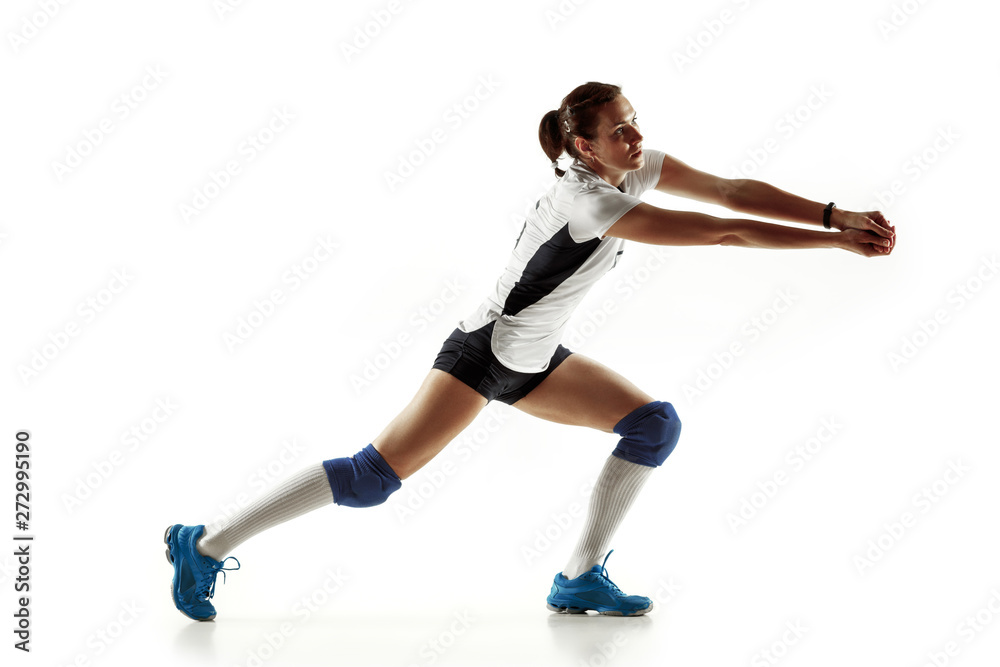Young female volleyball player isolated on white studio background. Woman in sport's equipment and shoes or sneakers training and practicing. Concept of sport, healthy lifestyle, motion and movement. Young female volleyball player isolated on white studio background. Woman in sport's equipment and shoes or sneakers training and practicing. Concept of sport, healthy lifestyle, motion and movement.
