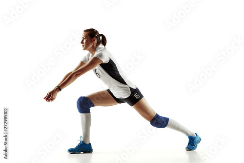 Fototapeta Naklejka Na Ścianę i Meble -  Young female volleyball player isolated on white studio background. Woman in sport's equipment and shoes or sneakers training and practicing. Concept of sport, healthy lifestyle, motion and movement.