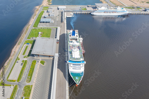 Passenger port with two cruise liners, preparing for departure on a trip.