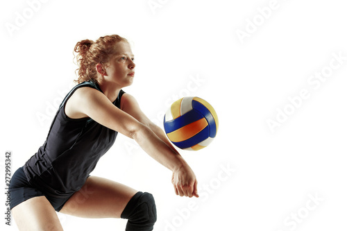 Young female volleyball player isolated on white studio background. Woman in sport's equipment and shoes or sneakers training and practicing. Concept of sport, healthy lifestyle, motion and movement.