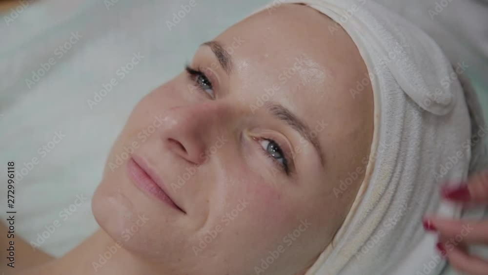 Professional beautician adjusts the patient's protective headgear. Professional beautician adjusts the patient's protective headgear.
