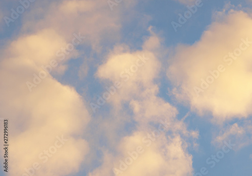 Summer background with white flying clouds on blue sky. Romantic natural heaven backdrop.