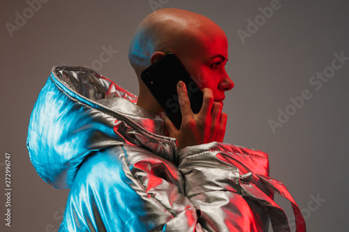 Fototapeta Portrait of an attractive bald woman wearing warm jacket
