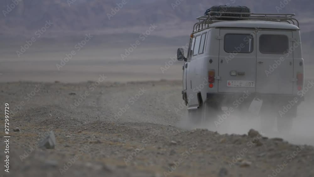 4x4 van driving through dirt roads and mountains in Mongolia Asia 4x4 van driving through dirt roads and mountains in Mongolia Asia