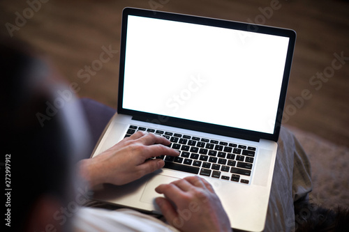 Man using notebook with blank screen