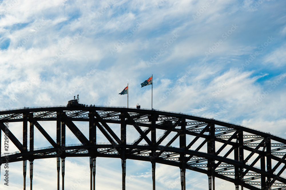 Australia flag fluttering above the Harbour Bridge.