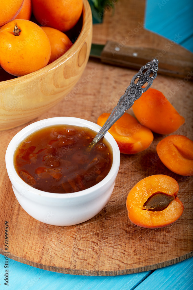 Apricot jam and fresh apricots in wood bowl. Apricot jam and fresh apricots in wood bowl.