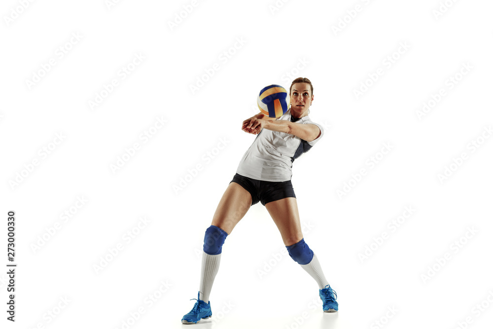Young female volleyball player isolated on white studio background. Woman in sport's equipment and shoes or sneakers training and practicing. Concept of sport, healthy lifestyle, motion and movement.