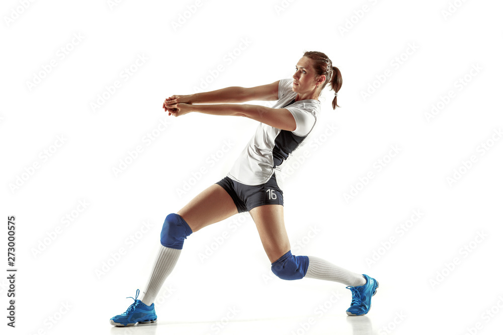 Young female volleyball player isolated on white studio background. Woman in sport's equipment and shoes or sneakers training and practicing. Concept of sport, healthy lifestyle, motion and movement. Young female volleyball player isolated on white studio background. Woman in sport's equipment and shoes or sneakers training and practicing. Concept of sport, healthy lifestyle, motion and movement.