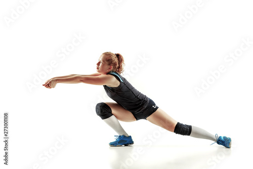 Young female volleyball player isolated on white studio background. Woman in sport s equipment and shoes or sneakers training and practicing. Concept of sport  healthy lifestyle  motion and movement.