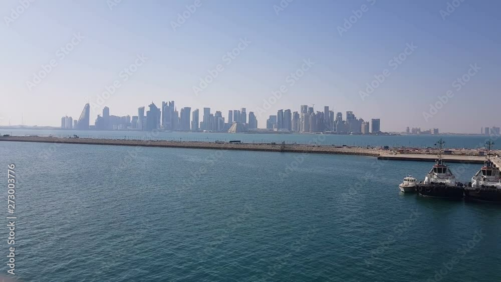 View of the pier with moored ships. Cargo seaport. Workers work in the cargo seaport. The mooring ropes on the pier. View of the pier with moored ships. Cargo seaport. Workers work in the cargo seaport. The mooring ropes on the pier.