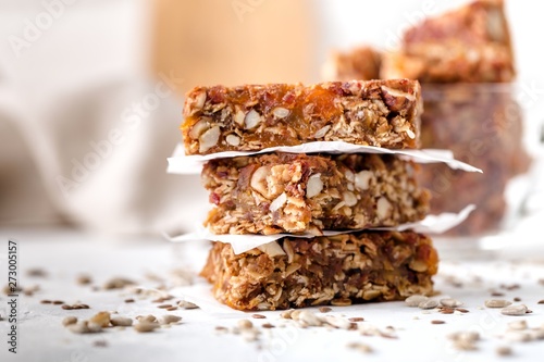 stack of fruit and nut bars, useful components, close up, for healthy concept. Light background