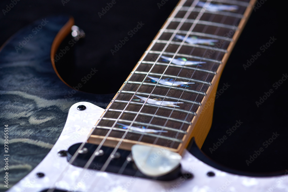 Fototapeta premium Electric guitar close up. Black background.