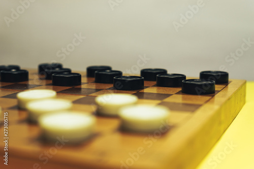 Chess baord with chess on a yellow table background. photo