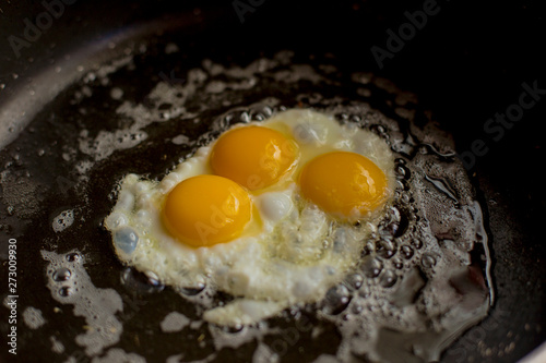 closeup eggs fried in pan