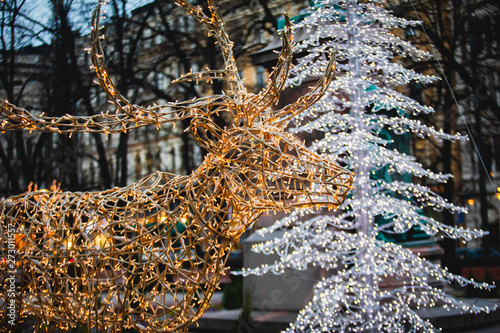 Christmas decorations in the streets of Helsinki, with evening light illumination, concept of Christmas in Finland, with deer made of lamps in Esplanade Park