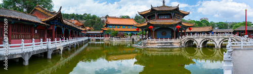 Serene atmosphere with temple, bridges and clear pool, Yuantong Buddhist Temple, Kunming, Yunnan, China, Asia photo